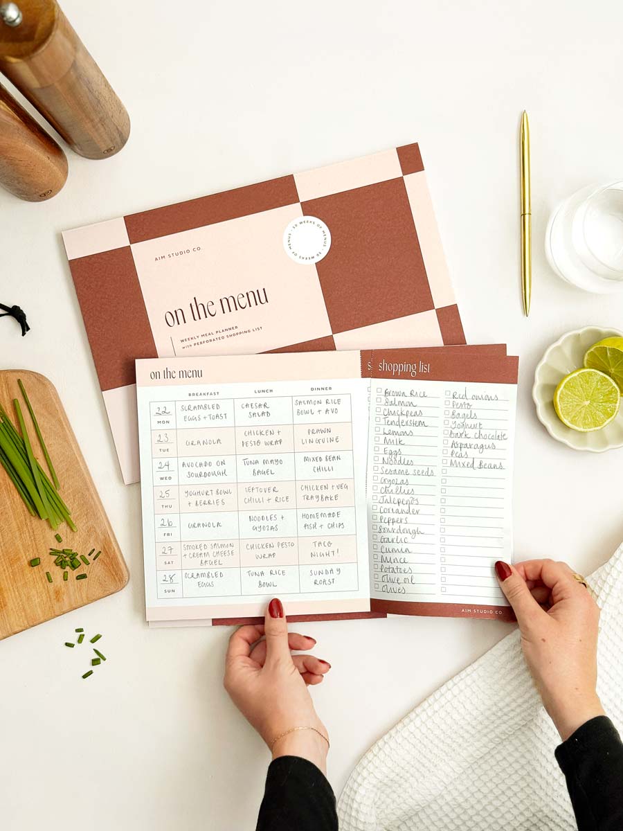 A4 meal planner pad with a checkered cover design and perforated notepad pages with shopping list