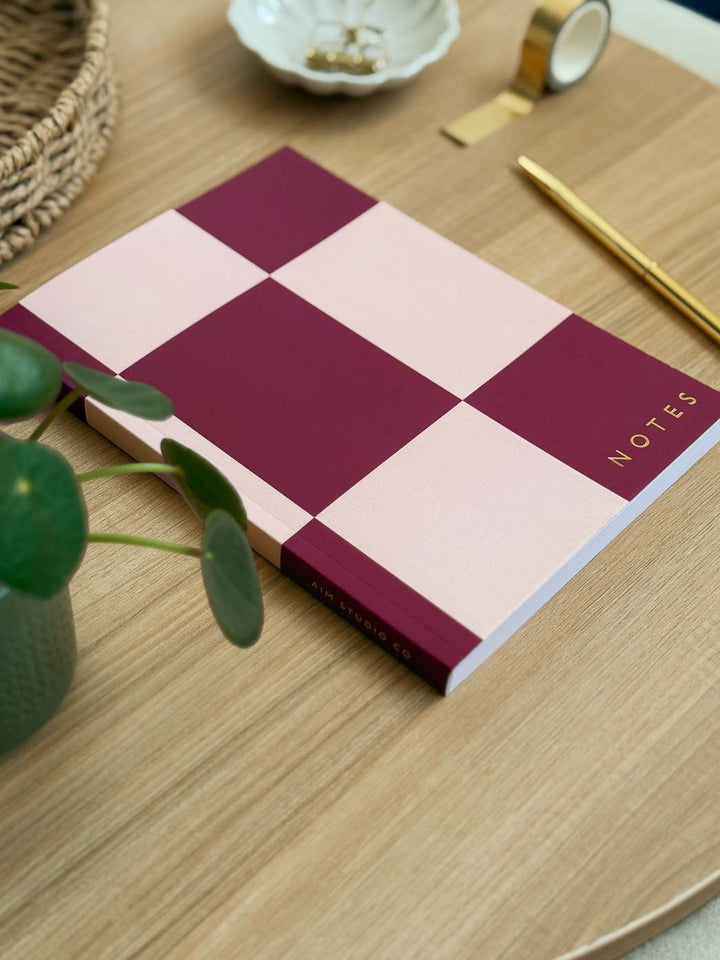 checkerboard A5 lined notebook with bold pink geometric cover