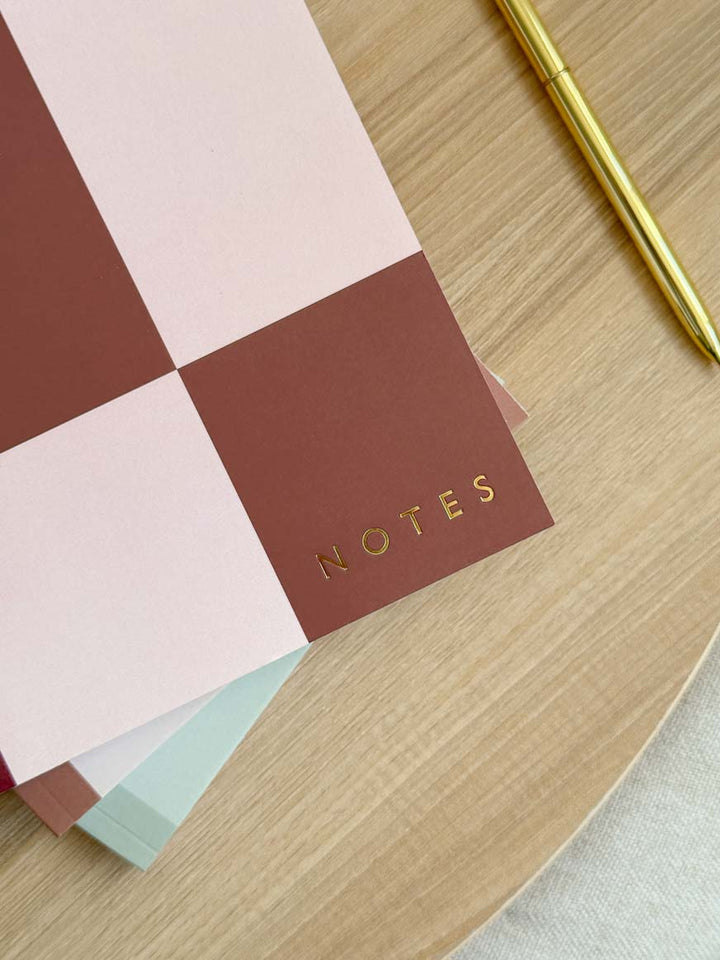 Notebook with geometric cover and gold foiled text embossed on the cover