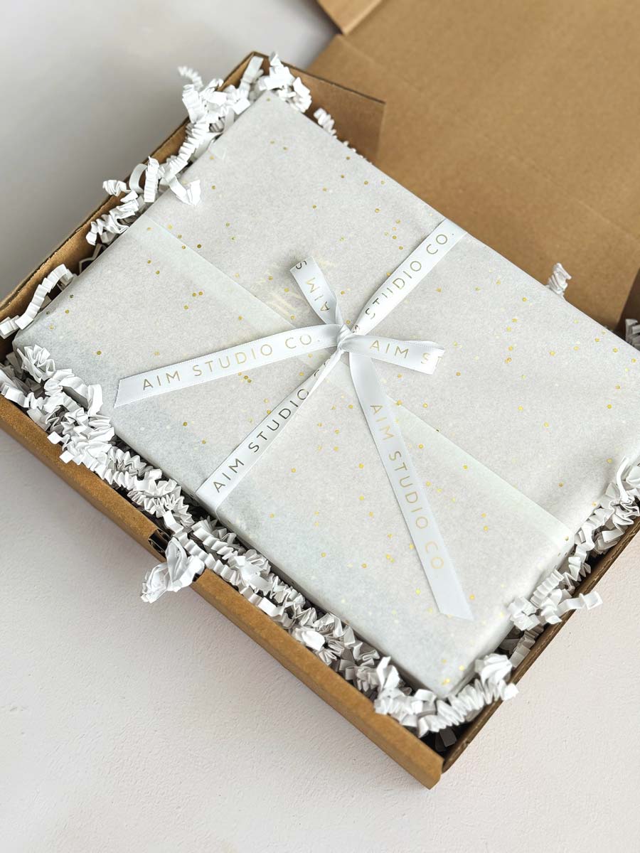 gift wrapped packaging of diary, notebook and pen set by aim studio co