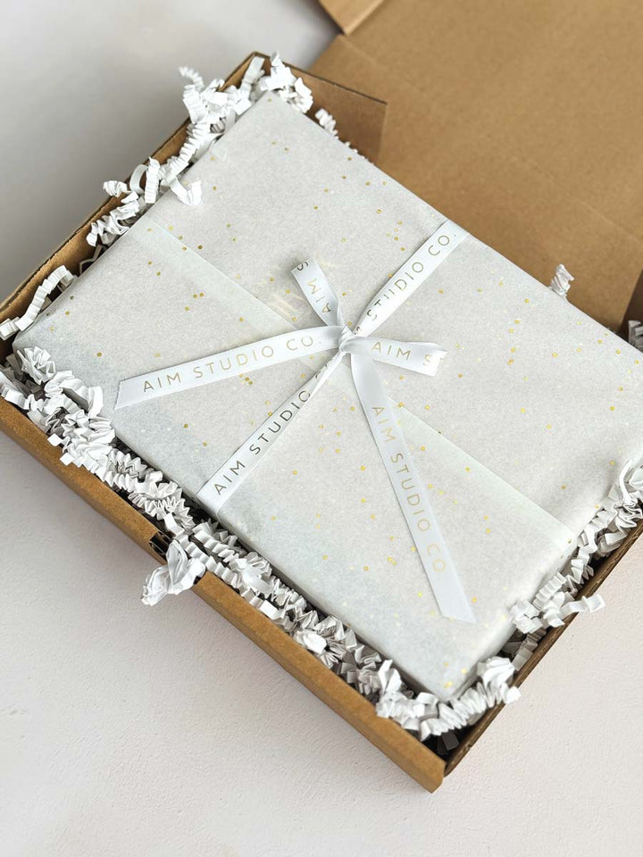 gift wrapped packaging of diary, notebook and pen set by aim studio co