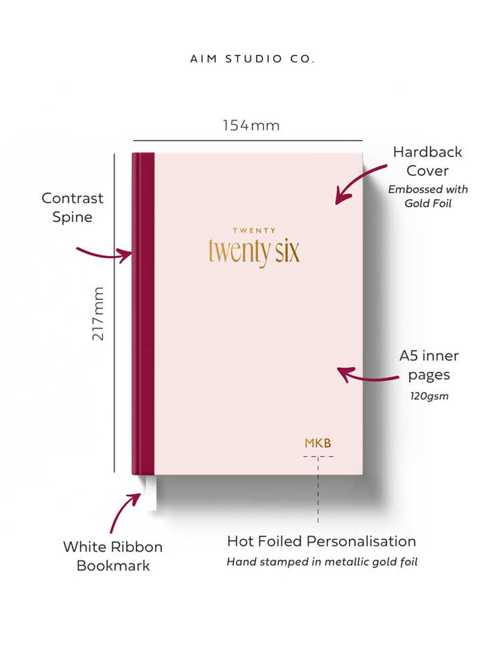 2026 pink hardback diary with information showing A5 size dimensions, white ribbon bookmark and week to view planner pages
