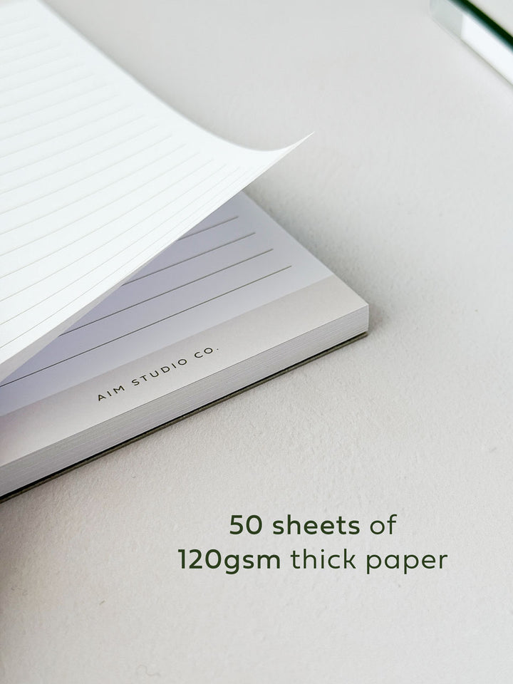 50 sheets of lined notepad pages showing thickness of premium paper