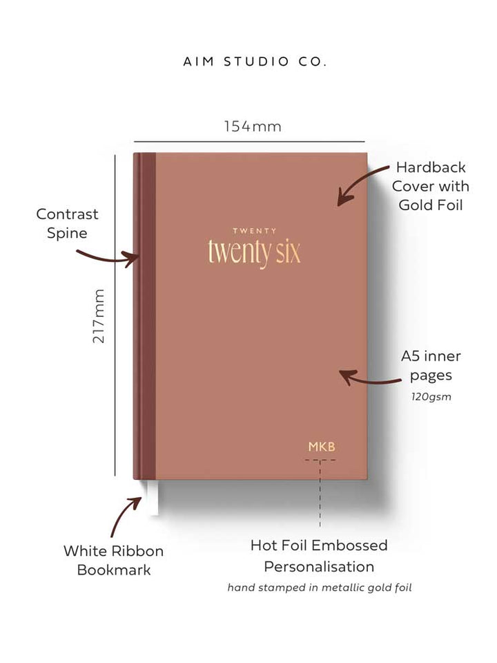 Brown weekly planner with gold foil '2026' lettering showing A5 dimensions and features such as white ribbon bookmark, hardback cover and week to view format.