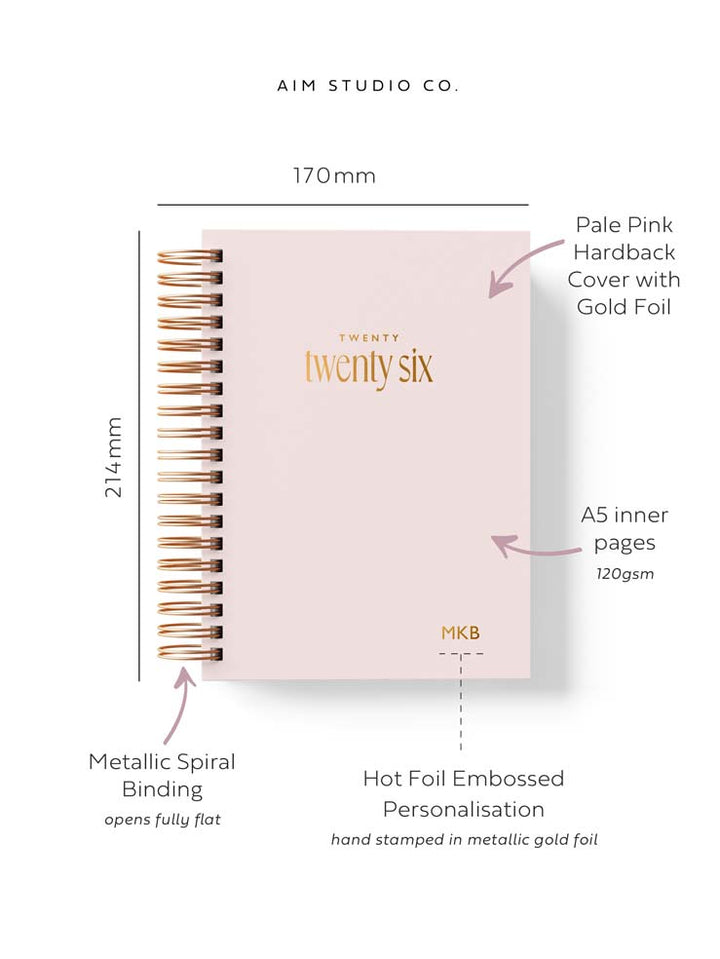 A5 sized 2026 hardback diary cover showing size dimensions and arrows with text reading metallic spiral binding and A5 weekly planner pages. It has gold foiled '2026' wording on the cover with personalised initials in the corner of the diary cover.