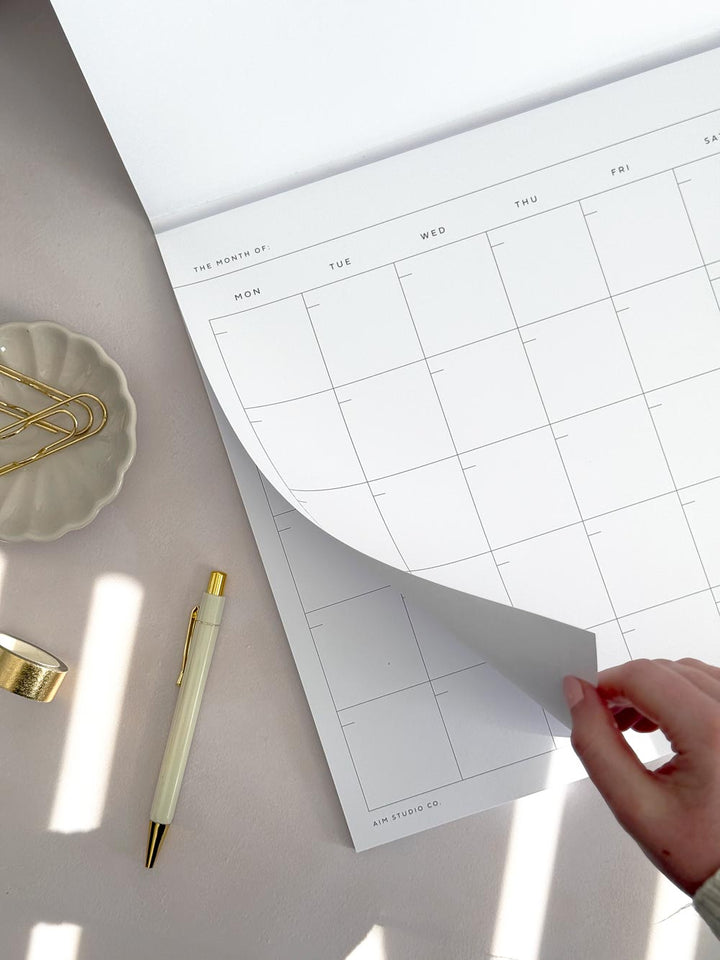 tear off month view planner page inside notepad with cover