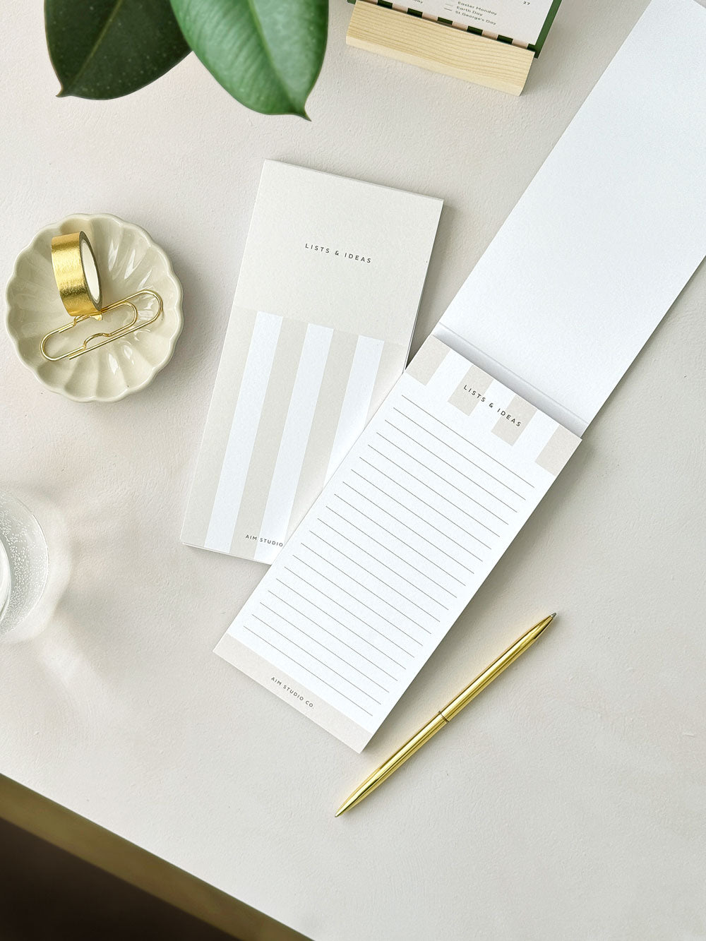 minimal beige and white stripe notepad on aesthetic desk setup showing stationery notepads and accessories designed for women
