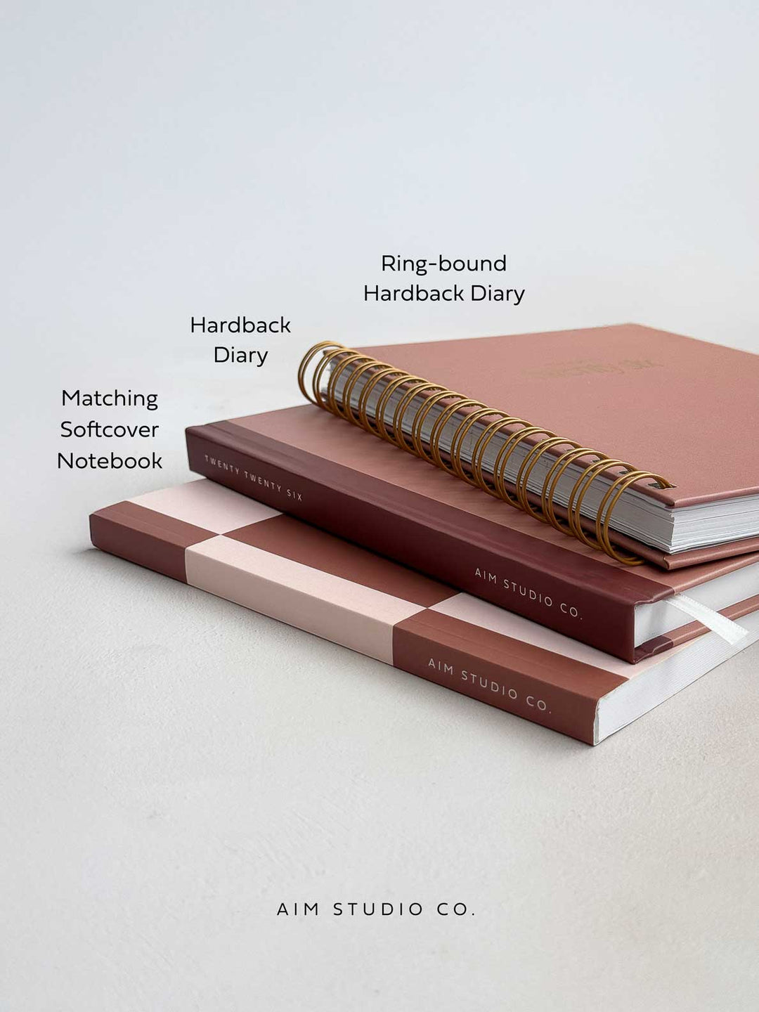 stack of 2026 diaries with matching notebook on an office desk in coordinated brown terracotta colour