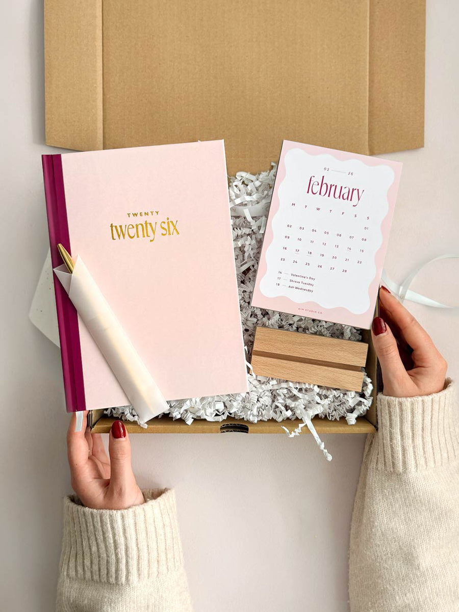 2026 planner bundle with pink hardback diary and 2026 monthly desk calendar with wooden holder
