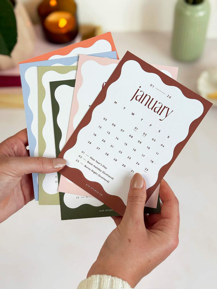 small 2026 calendar cards showing UK bank holidays with a wavy colour block border