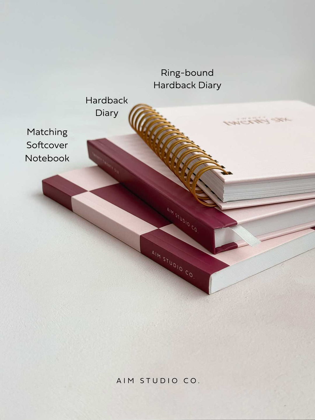 hardback 2026 diaries with matching notebook in a stack on office desk
