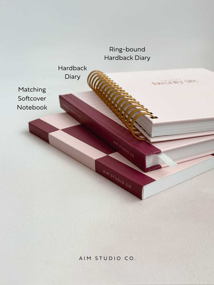 hardback 2026 diaries with matching notebook in a stack on office desk