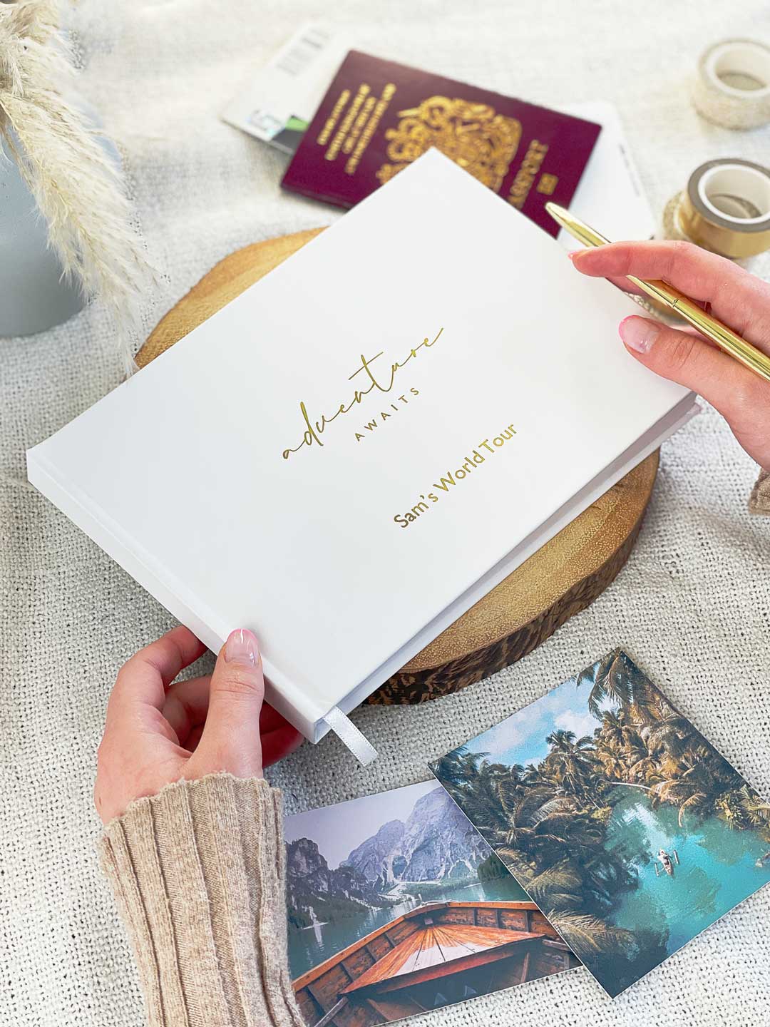 white hardcover scrapbook with gold foiled cover design reading adventure awaits and personalised message embossed on the cover in gold