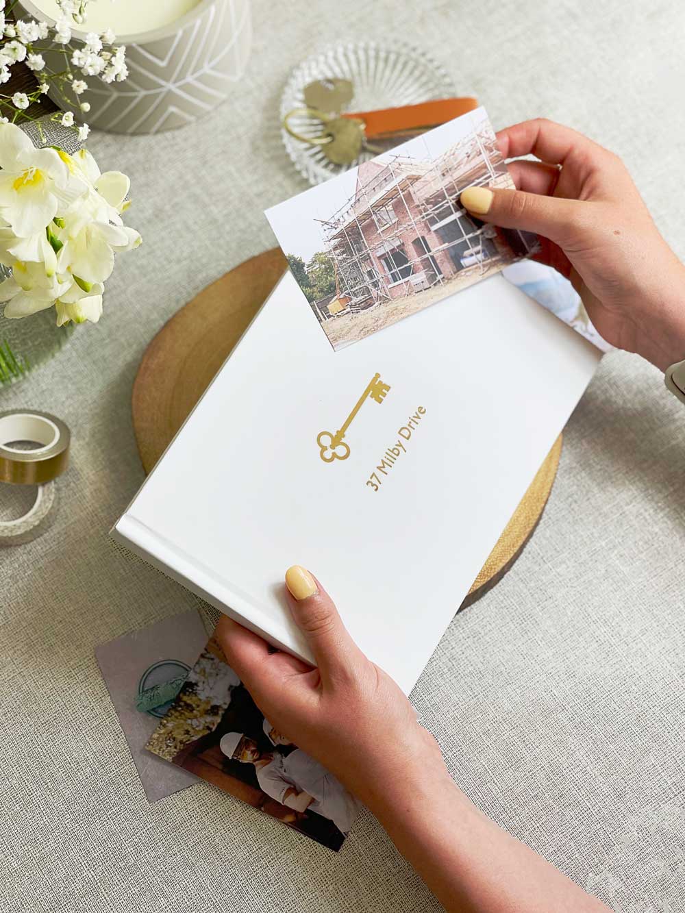 Photos and personalised memory book for couples scrapbooking their first home journey
