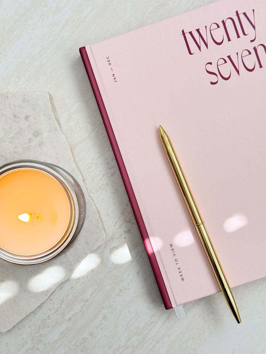 Close up of hardback pink 2027 diary with bold red &