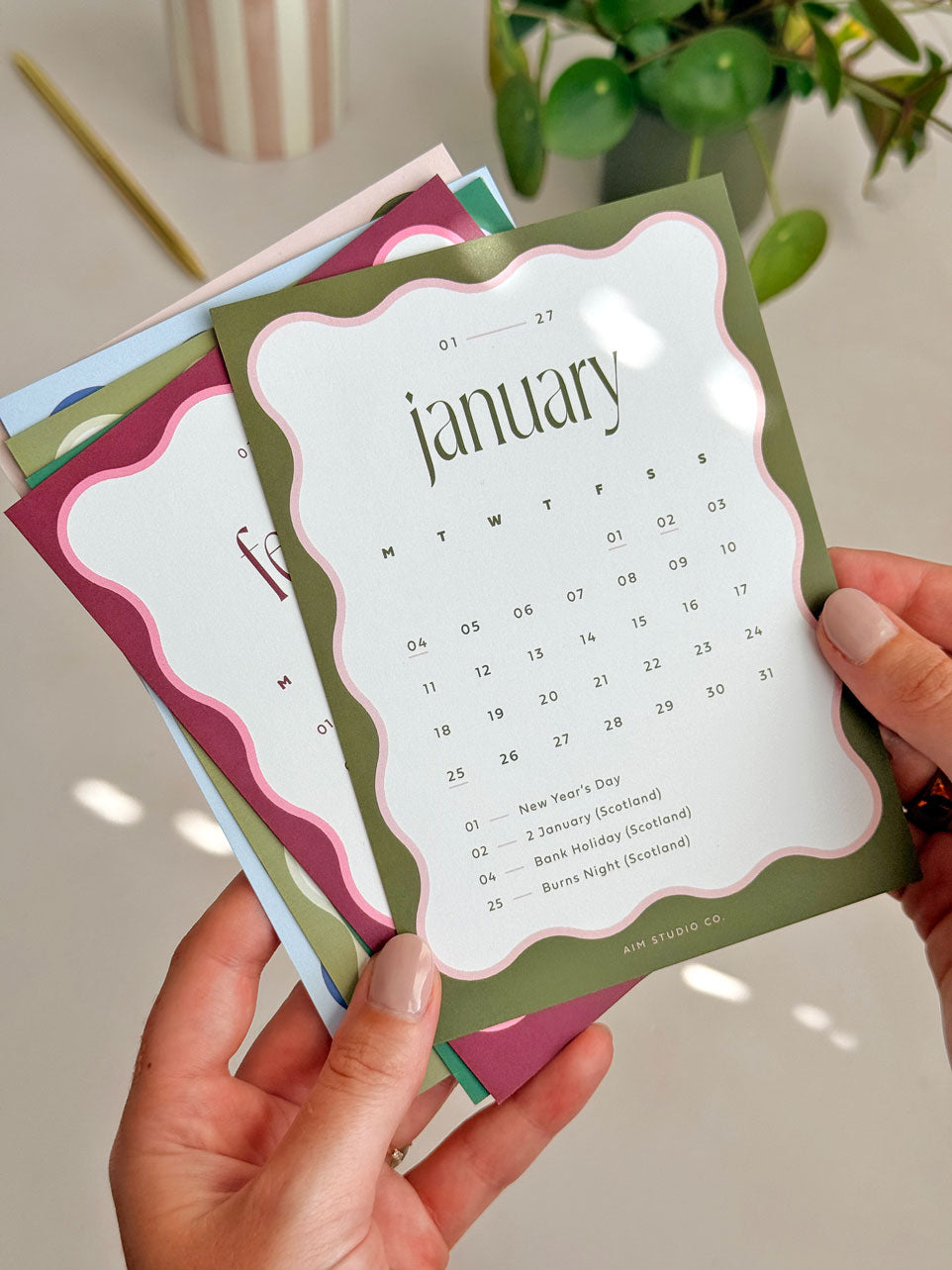 Olive green a6 desk calendar cards with wavy scalloped border design showing refill pack for 2027 desk calendar by aim studio co.