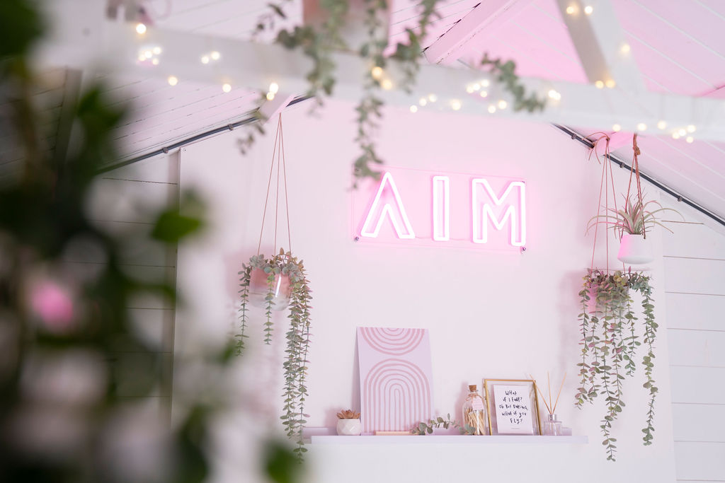 AIM Studio Co neon logo sign in aesthetic office