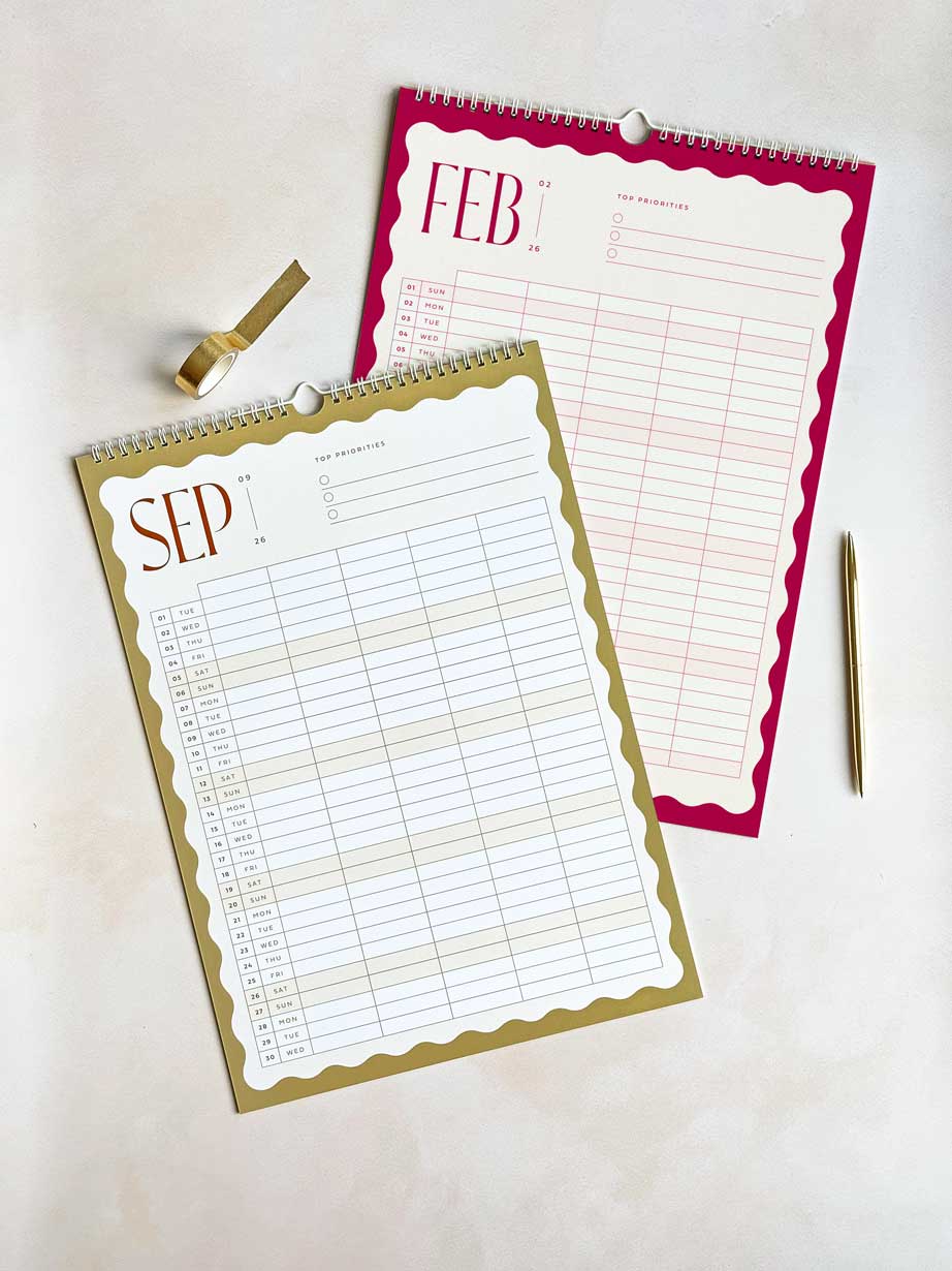 flat lay of 2026 family planner showing september and february monthly overviews