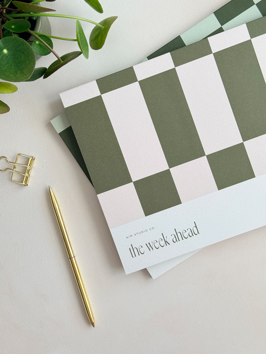 close up of A4 weekly notepad cover with pink and olive green geometric design