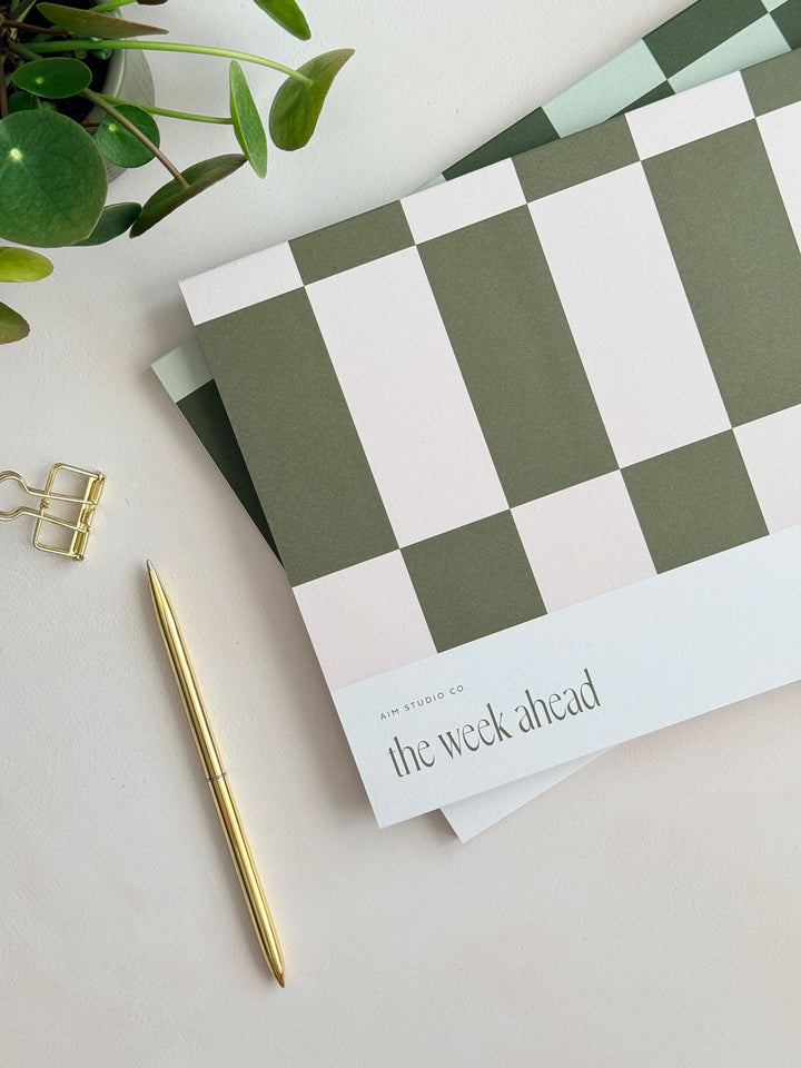 close up of A4 weekly notepad cover with pink and olive green geometric design
