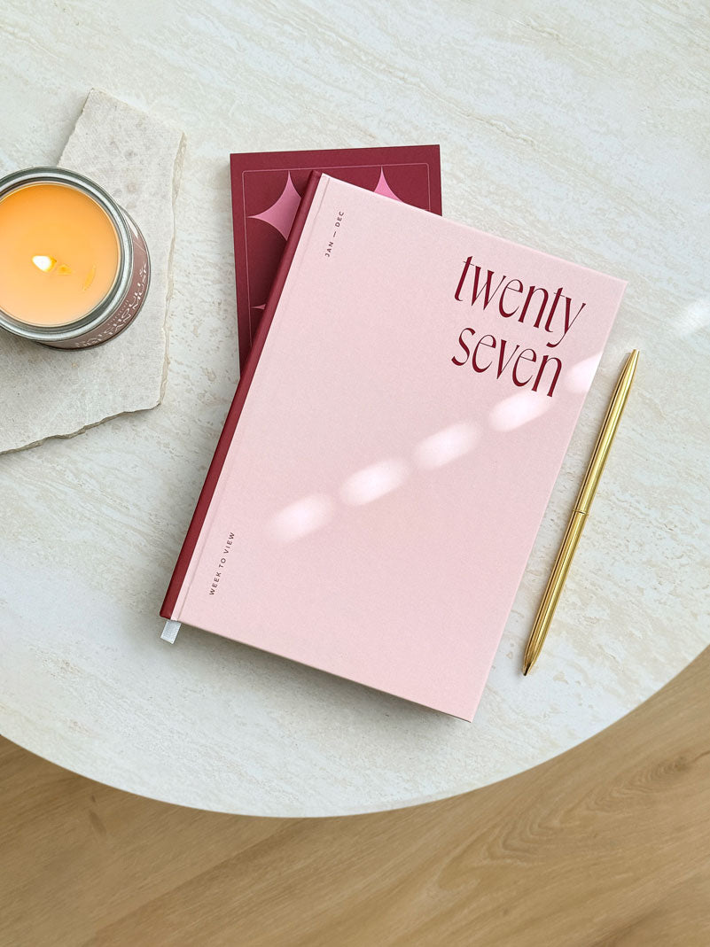 A pink hardcover diary with the &