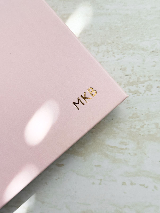Close up of gold foiled intials embossed in gold foil on the cover of a 2027 pink planner by AIM Studio Co.