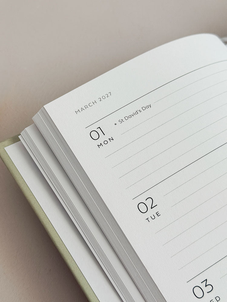 An open 2027 weekly planner showing a week in march, with lined pages for appointments and schedule. UK bank holidays and occasions are written in a smaller font.