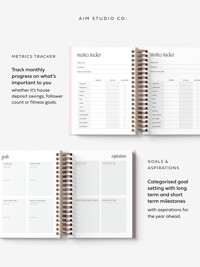 Inside pages of 2027 spiral planner showing goal setting pages and metrics tracking.