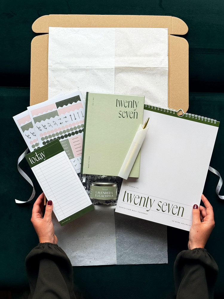 The Sage Year Ahead Set: a sage green hardback 2027 diary in a stationery gift bundle with a time blocking planner, minimalist wall calendar, planner sticker sheets and a candle.