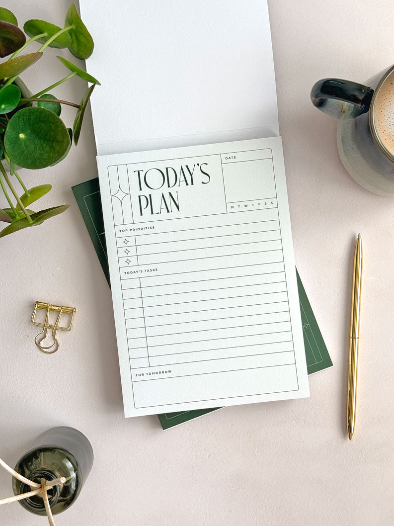 A daily planner notepad with &