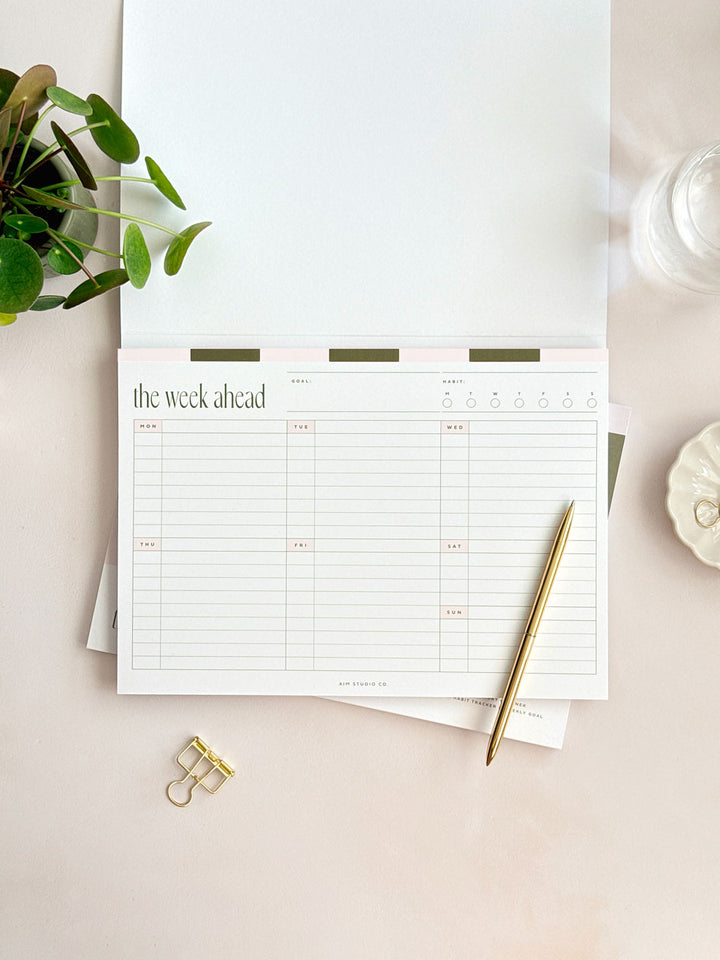 inside pages of a4 weekly planner notepad showing monday to sunday undated planner page with habit tracker and weekly goal setting