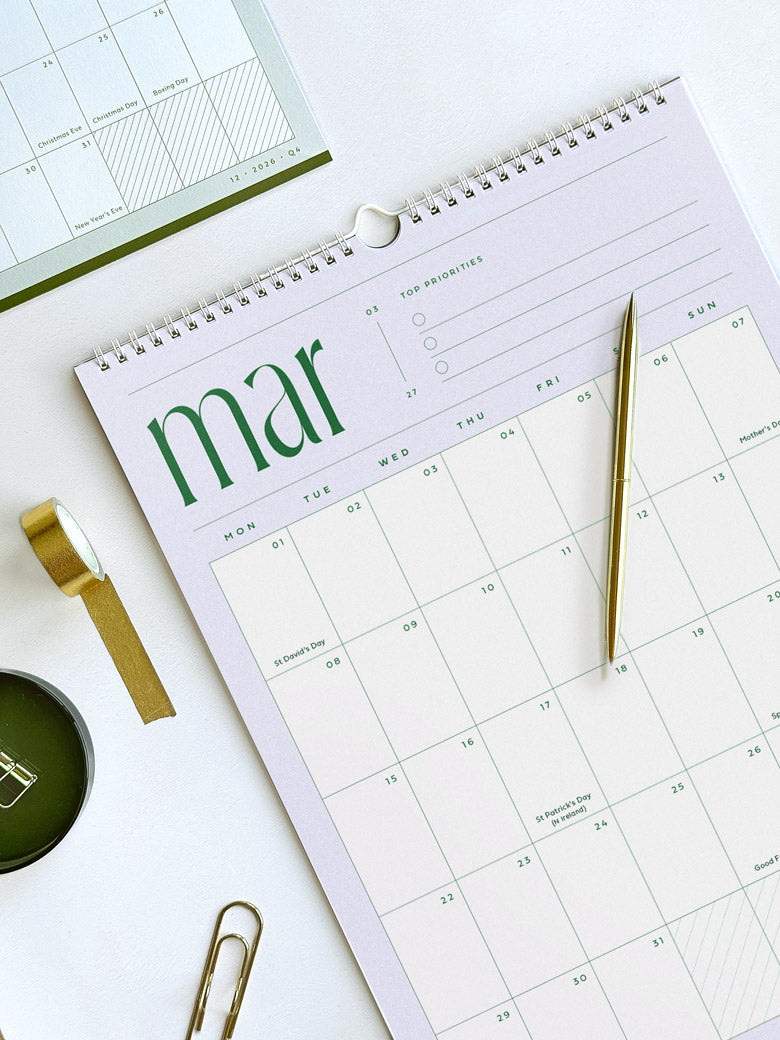 2027 monthly calendar showing lilac and deep green page of march 2027 with minimalist typography and month view planner grid with UK bank holidays and space for top three priorities per month.