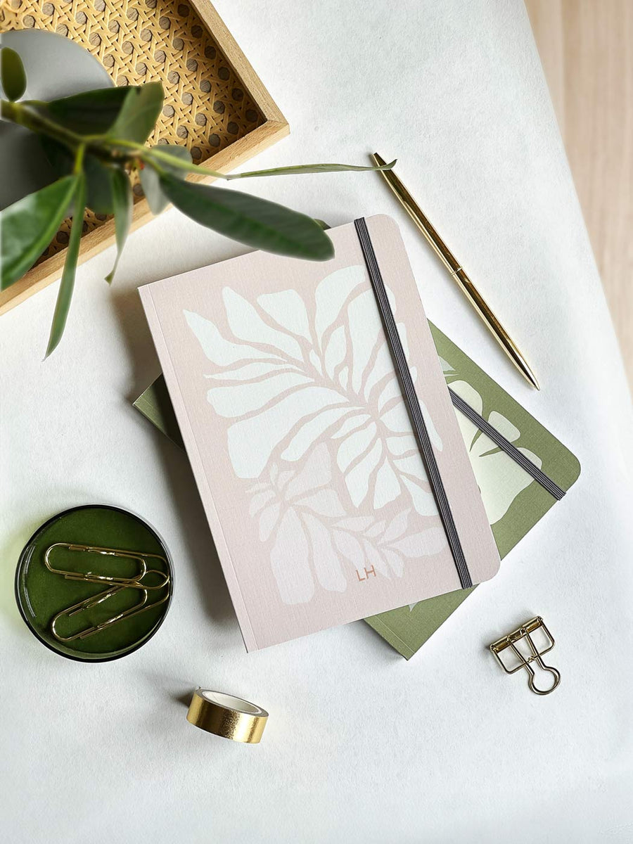 personalised feminine pink notebook with linen cover texture and botanical leaves illustration