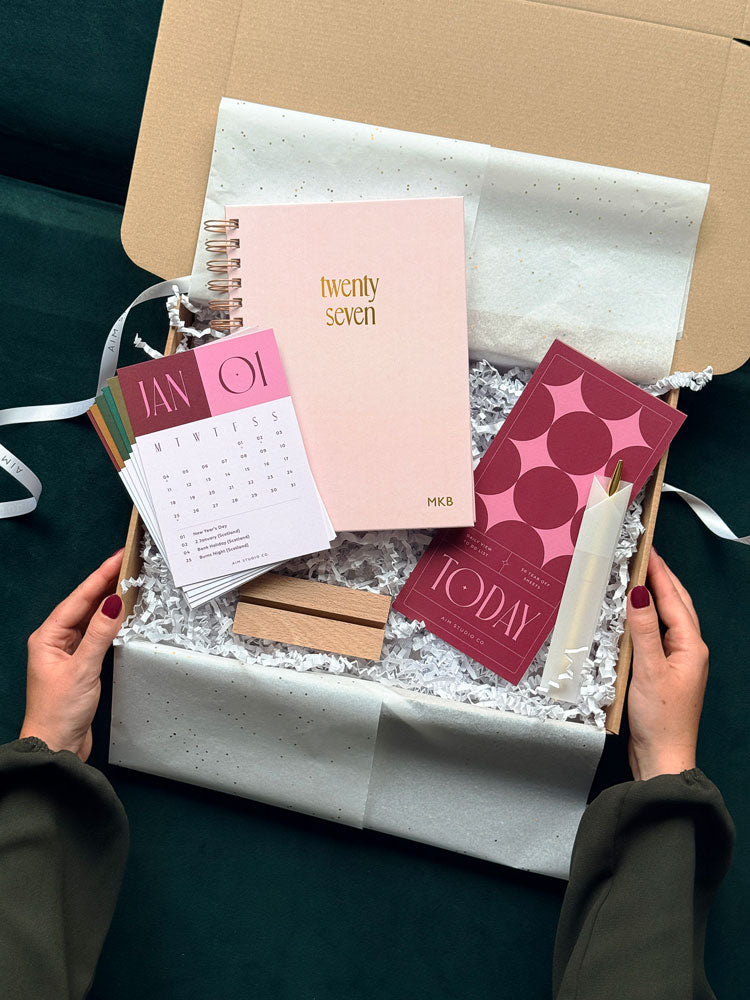 a personalised stationery gift bundle with pink and burgundy desk accessories for women. It&