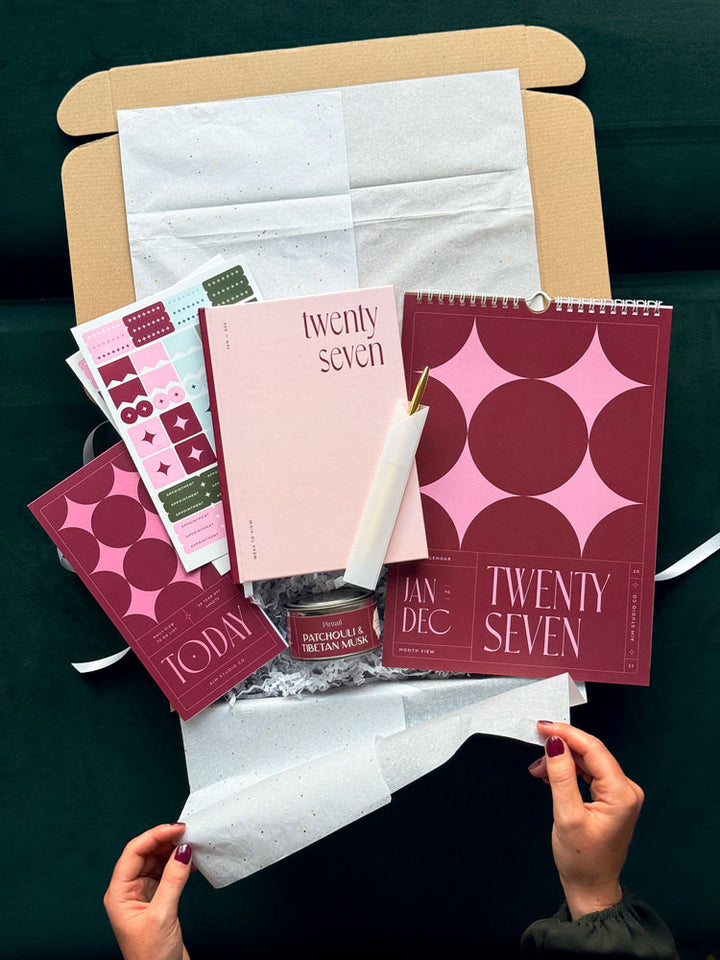 The Pink Year Ahead Set: a pink and burgundy stationery gift bundle with a personalised 2027 diary, colour block wall calendar, planner stickers, slim to do list notepad, gold pen and candle by AIM Studio Co.