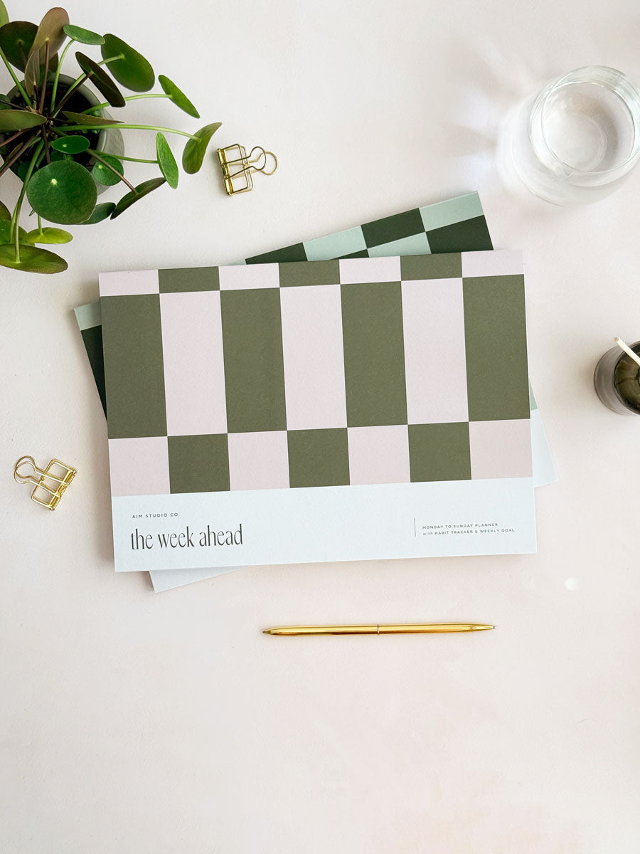 checkered weekly planner with 'the week ahead' text with pink and olive green geometric design 