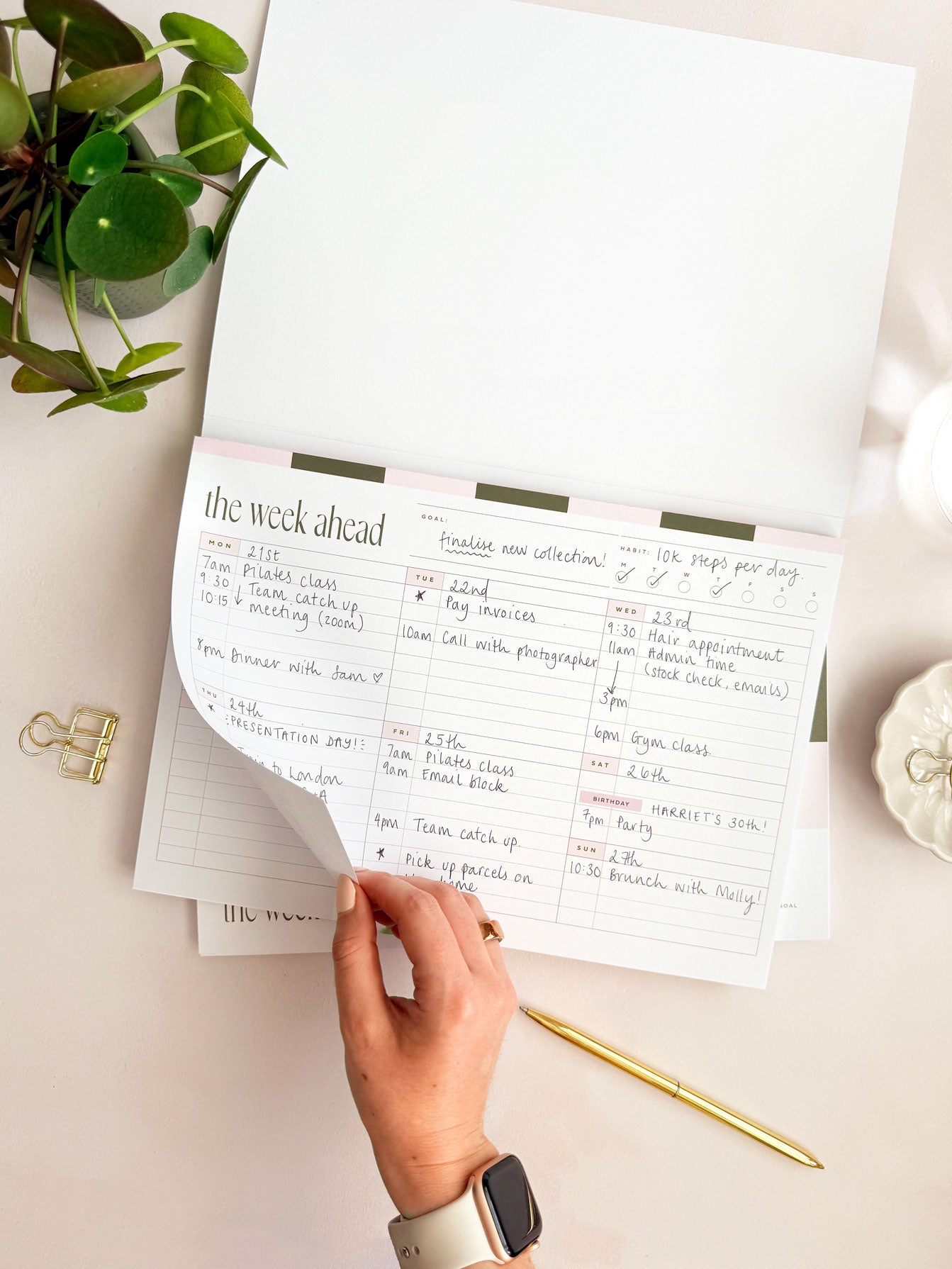 tearing off notepad page showing weekly schedule and to do for the week