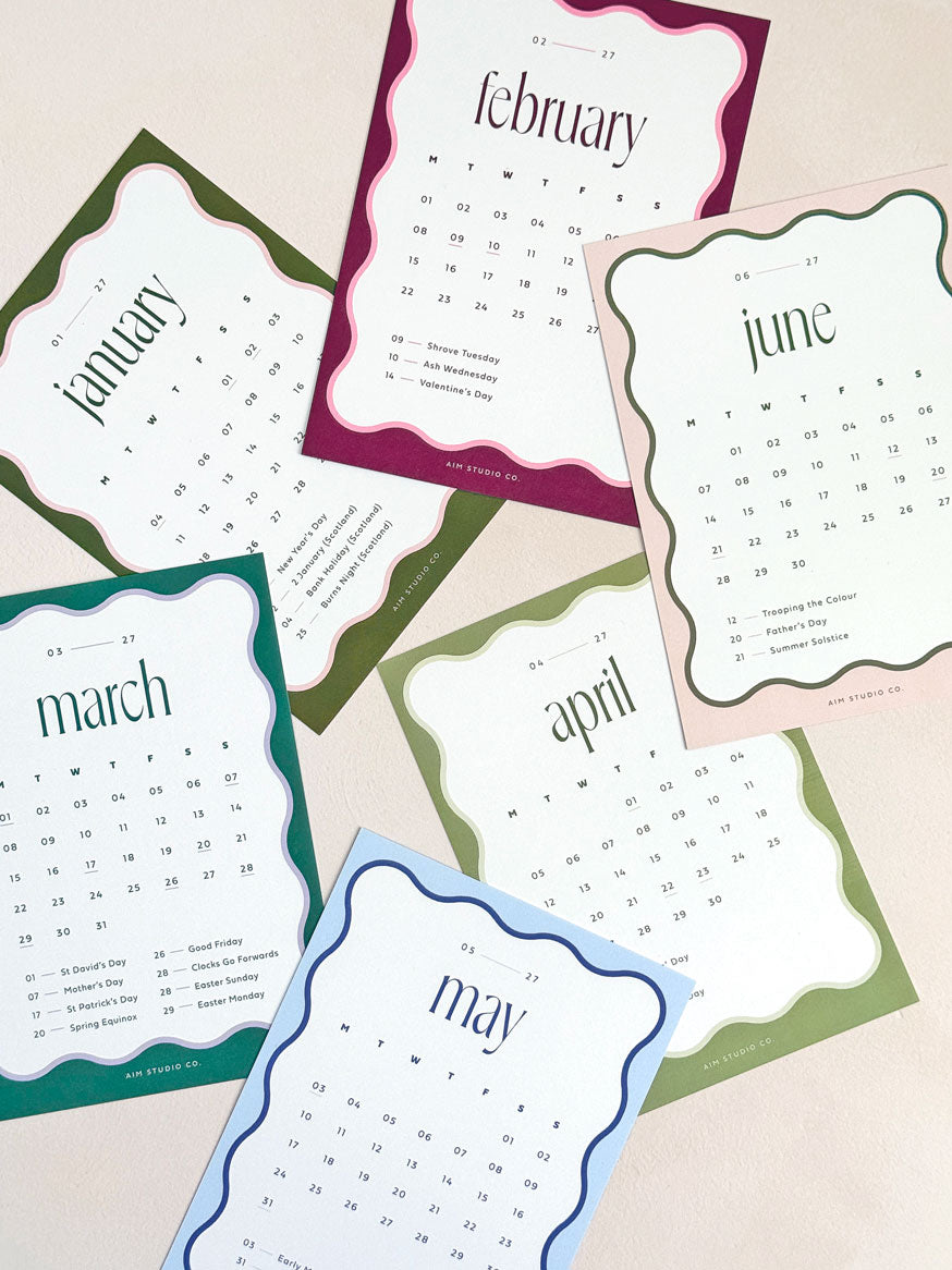 a6 calendar cards showing month view dates with maked bank holidays for the UK. All cards have a scalloped wavy border in bold colours with modern serif typograhy of the month name.