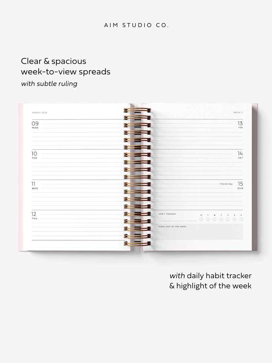 spiral planner open flat showing weekly layout diary pages with UK bank holidays and a daily habit tracker
