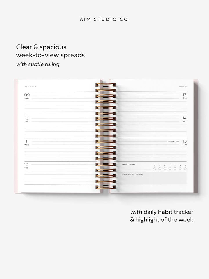spiral planner open flat showing weekly layout diary pages with UK bank holidays and a daily habit tracker