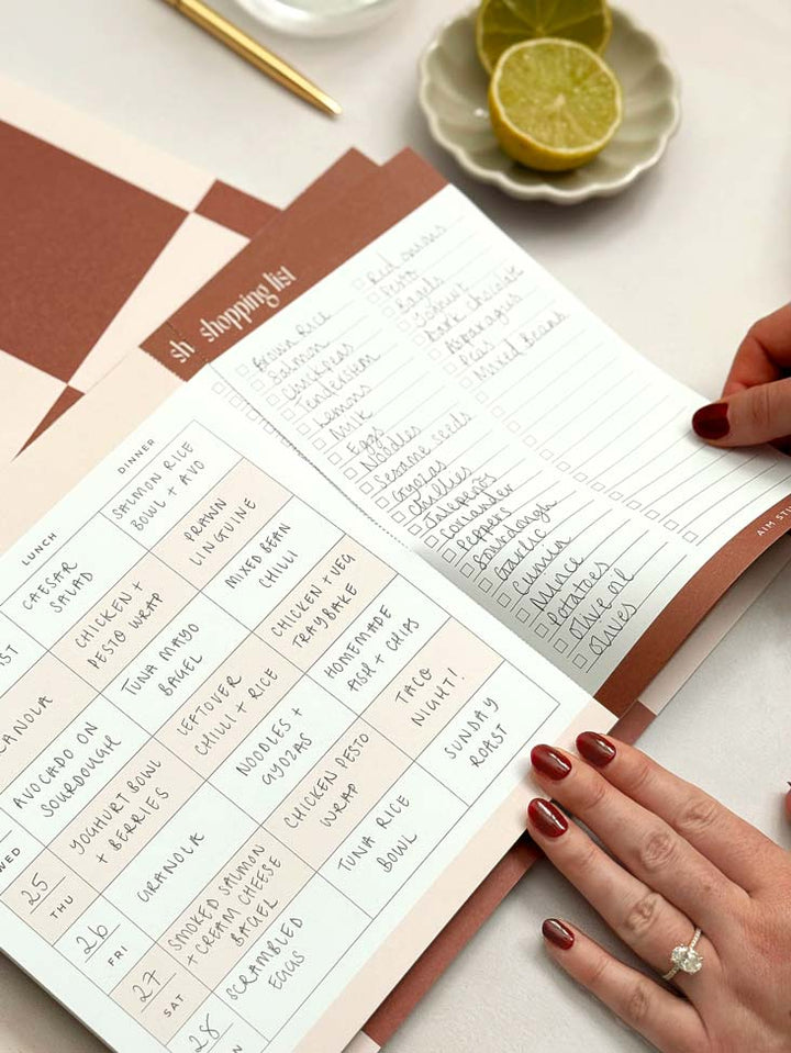 close up of perforated notepad page to detach shopping list from weekly menu plan.