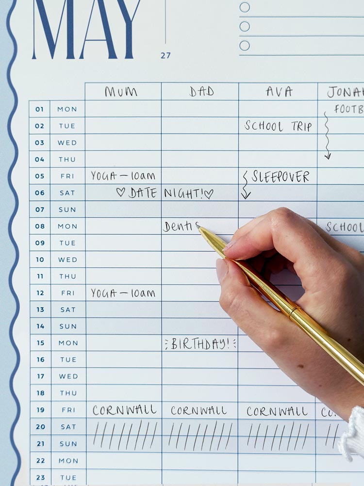 close up of writing on family wall planner with 5 column grid and 2027 dates