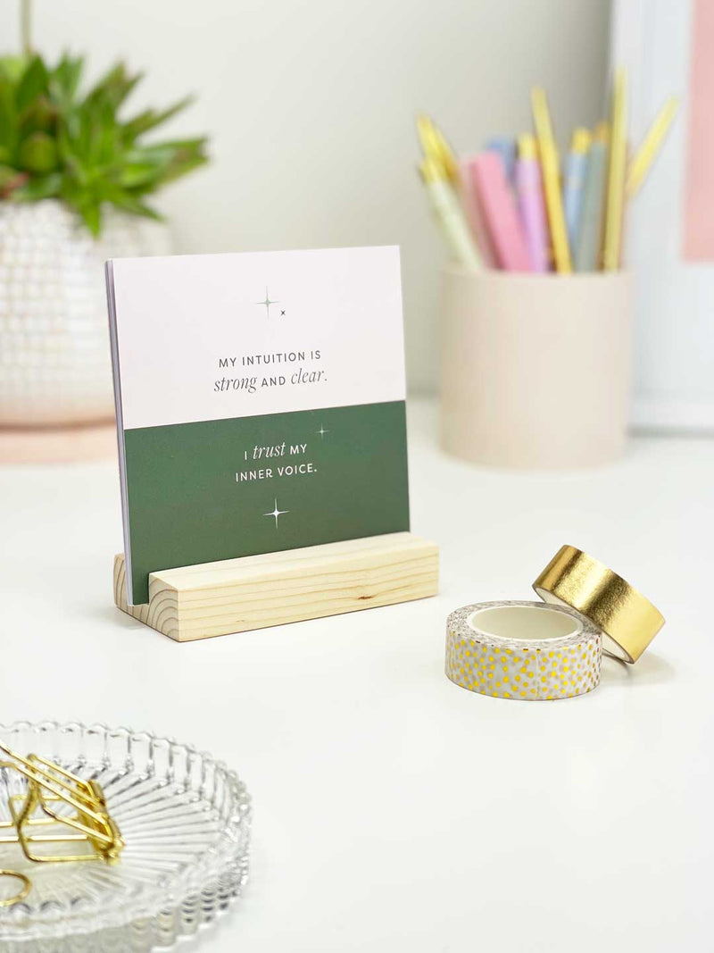 Blush pink and green affirmation card with positive mindset quote on office desk with stationery and office accessories