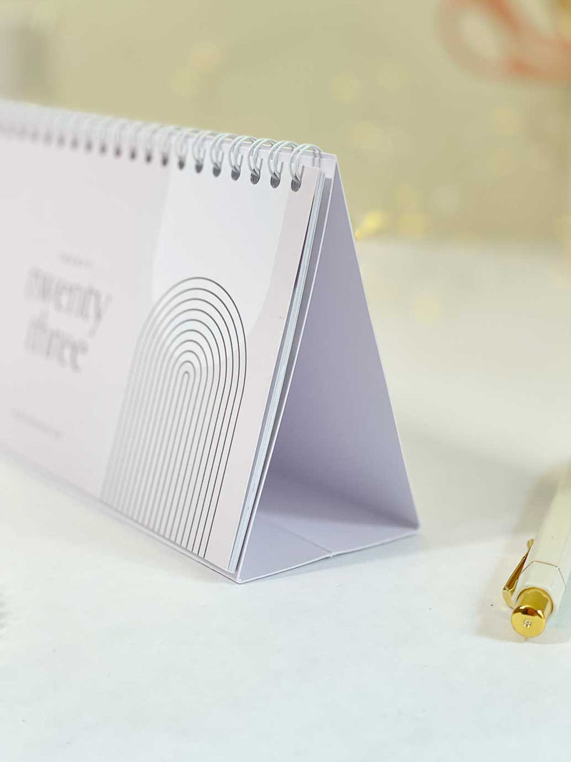 A close up image showing 2023 wire bound calendar with pop up card base