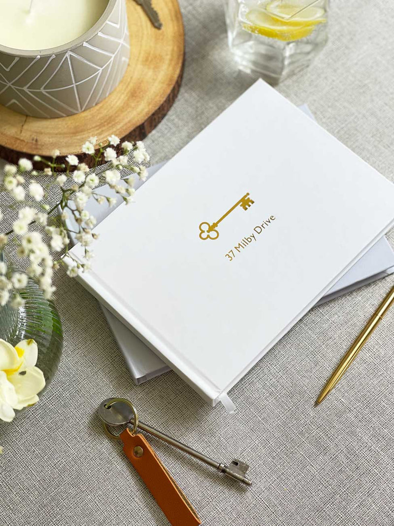 White and gold foil hardcover scrapbook personalised with house name and number for couples housewarming gift
