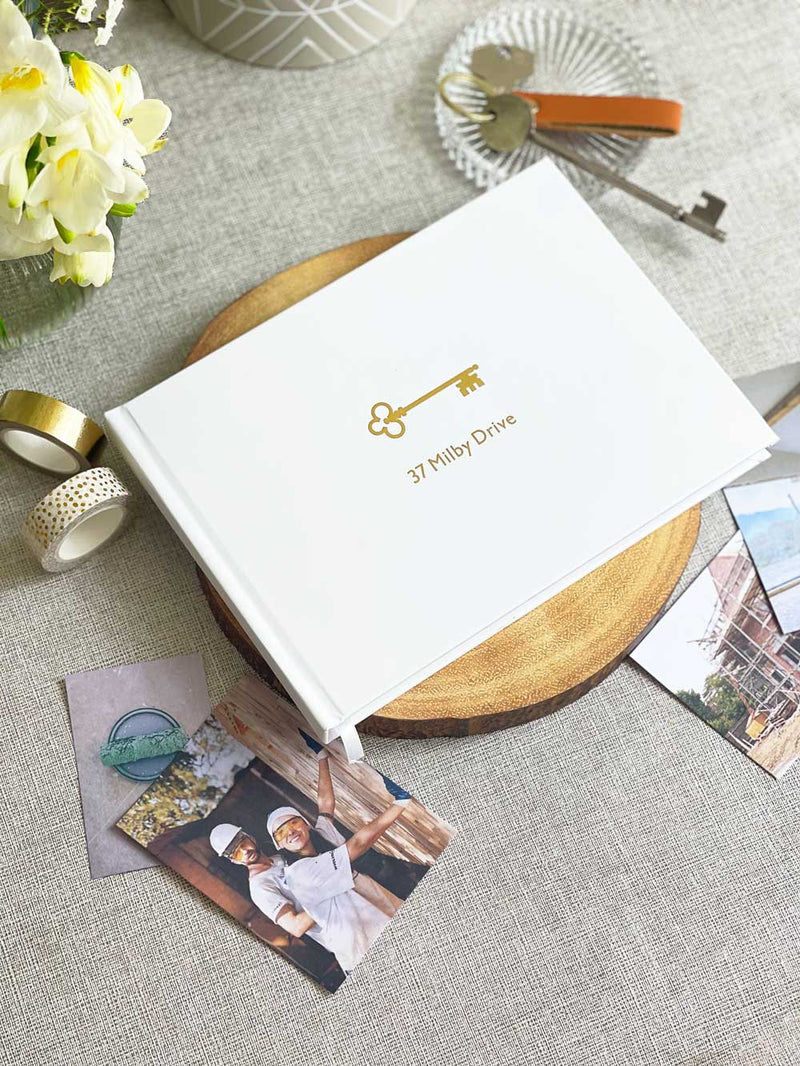 A5 White memory book with gold foiled key design and personalised house name for new homeowners housewarming gift from family