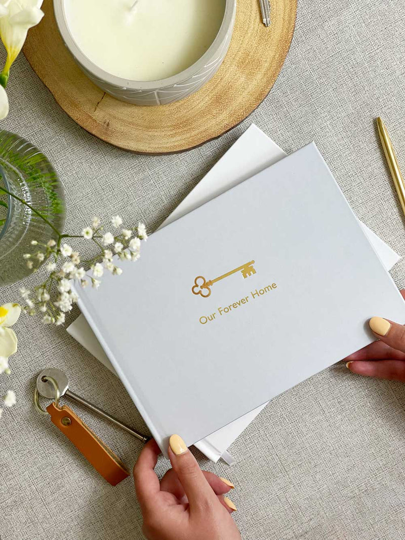 New Home Memory book reading our forever home in gold foil with gold key design on the cover
